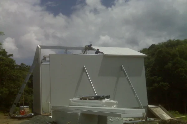 Installing insulated wall and roof panels