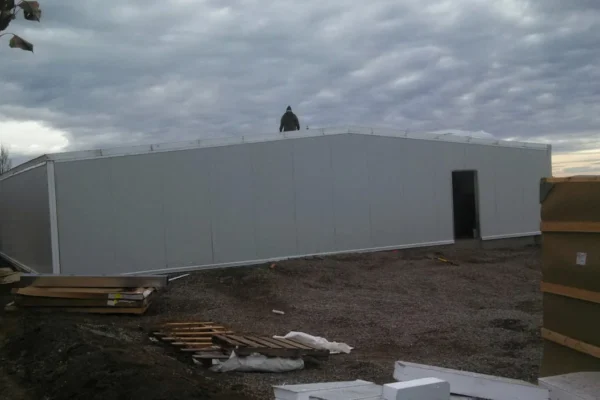 Worker assembling insulated roof structure on site